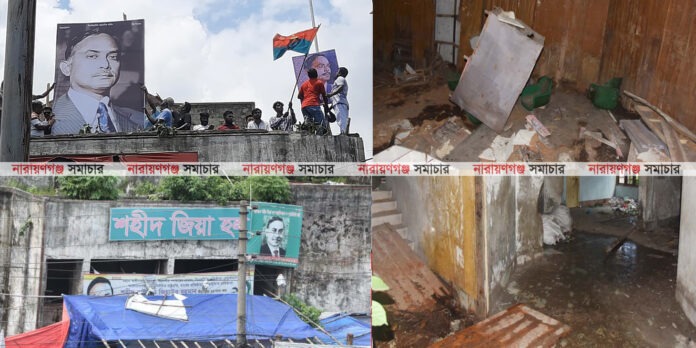 zia-hall-narayanganj-abandoned-political-vengeance নারায়ণগঞ্জের চাষাঢ়ায় অবস্থিত পরিত্যক্ত শহীদ জিয়া হলের সামনের দৃশ্য, যার দেয়ালে গাছ ও শ্যাওলা জন্মেছে।